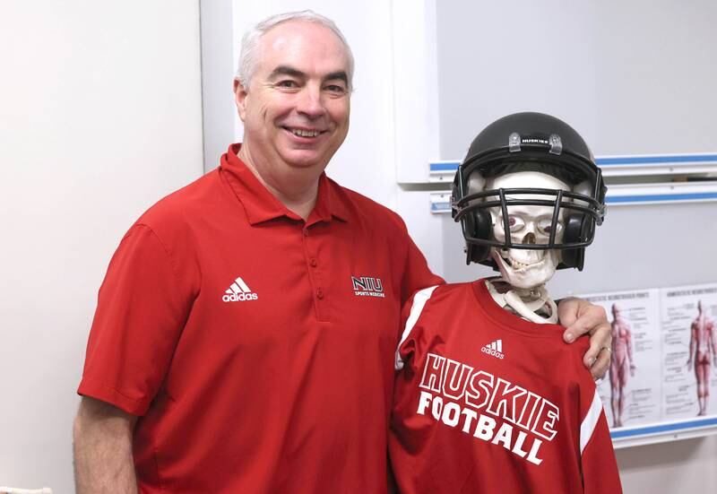 Phil Voorhis, Associate Athletic Director for Sports Medicine and Athletic Training at Northern Illinois University, with a friend Tuesday, March 26, 2024, in the athletic training room in the Yordon Center at NIU in DeKalb.