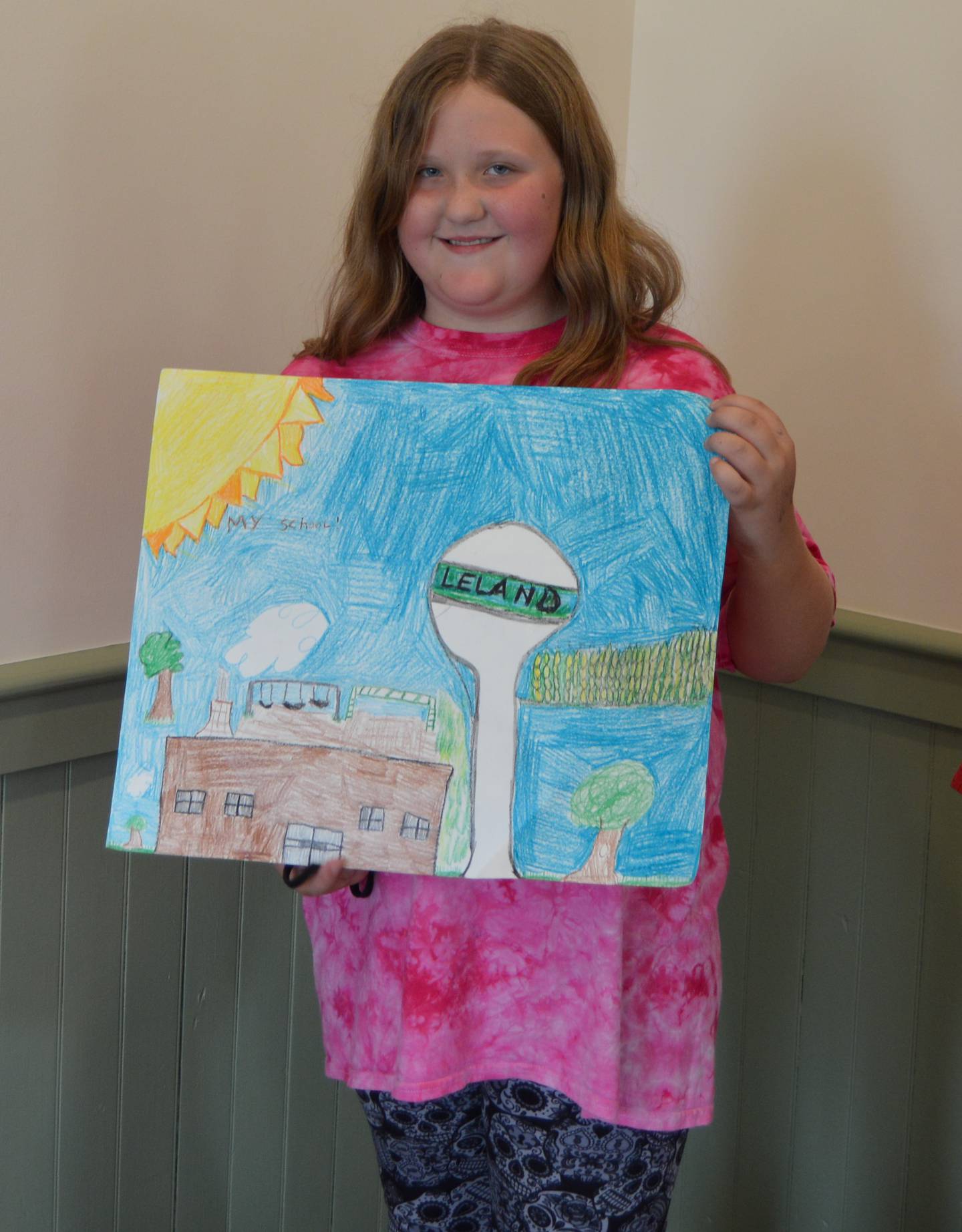 Willow Huntington, fourth grader at Leland Elementary, shows off her artwork.