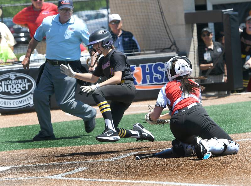 Casey-Westfield's Rachel Warfel avoids the tag at home by Forreston's Hailey Greenfield during semifinal action at the 1A softball finals in Peoria on Friday, June 3. The Cardinals lost the game 4-0 and will place Newark for third place on Saturday, June 4.