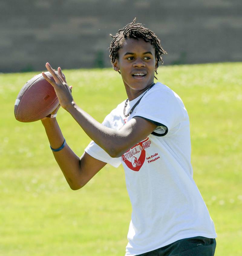 Lebron Carrignton, 13 throws a pass during the inaugural Legends of the 60115 Football Camp with NIU’s Cole Tucker in DeKalb on Sunday, June 26, 2022.
