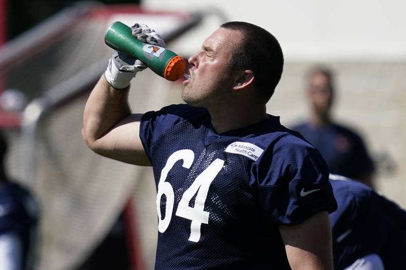 Chicago Bears offensive line Michael Schofield grabs a quick drink during the team's training camp, Saturday, July 30, 2022, in Lake Forest.