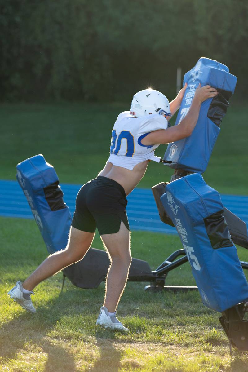 Running back Luke Beedle practices blocking during practice at Wheaton North on Thursday, Aug. 11, 2022.