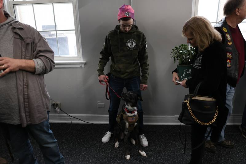 Ben Rubinberg, an Army Reserve veteran, stands with his service dog Cooper, an Australian Shepard Catahoula Leopard mix, on Wednesday, Feb. 15 at the K9s for Veterans training campus in Joliet. K9s for Veterans hosted a ribbon cutting ceremony for the opening of its Joliet training campus
