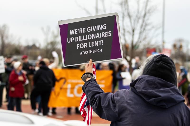 An attendee holds up a sign at the Hands Off protest in Downtown Joliet on April 5, 2025.