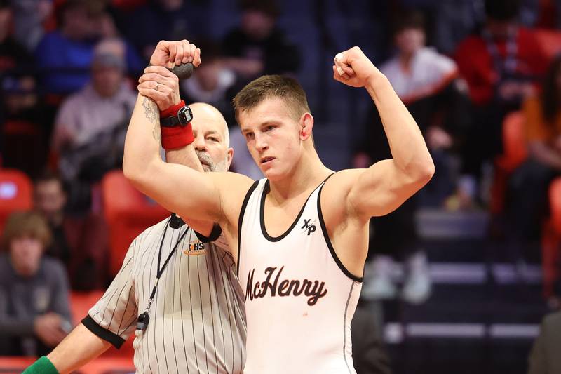 McHenry’s Chris Moore holds up his fist after his win over Mt. Carmel’s Collin Kelly in the 170-pound Class 3A championship match on Saturday, Feb. 18, 2023 at State Farm Center in Champaign.