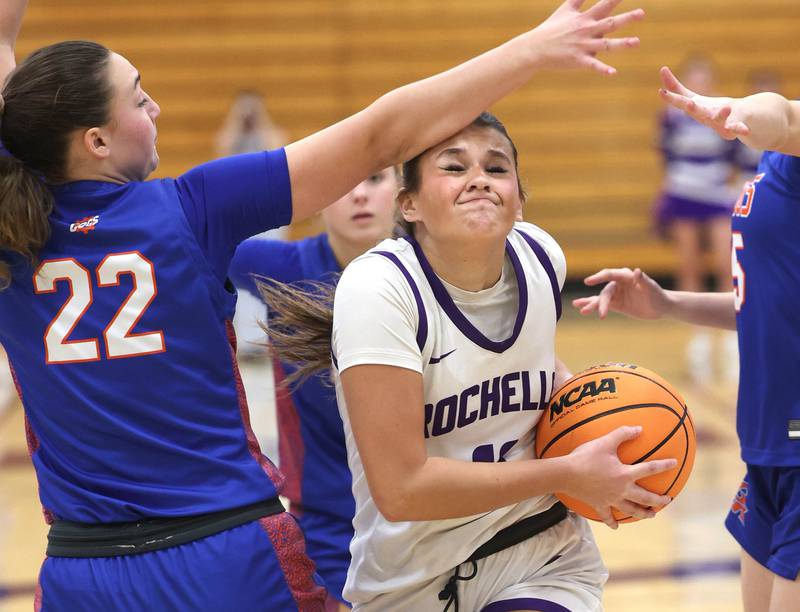 Rochelle's Audrina Rodriguez gets hit in the head by Genoa-Kingston's Regan Creadon as she goes to the basket during their game Monday, Dec. 15, 2025, at Rochelle High School.