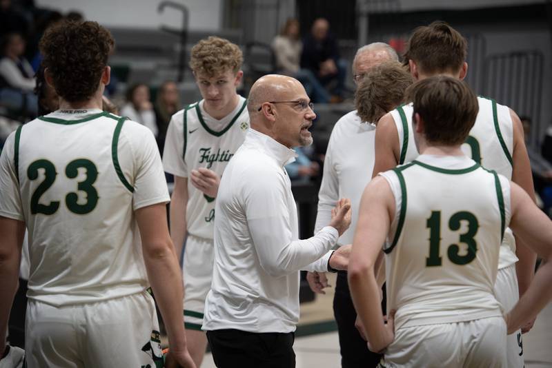 Bishop McNamara's head coach Adrian Provost, center, talks with his team during a timeout in a game against Newark on Friday, Feb. 20, 2026.