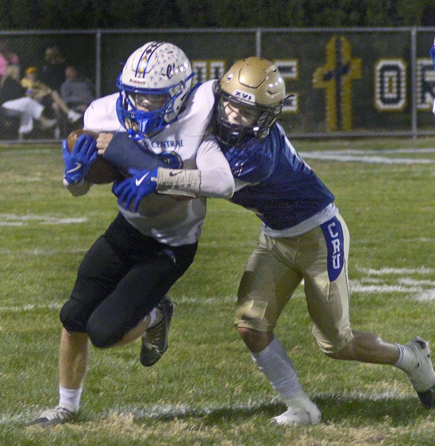 Aurora Central Christian’s Aiden Crisco fights his way past Marquette’s Koby Clark on a run in the first quarter Friday in Ottawa.