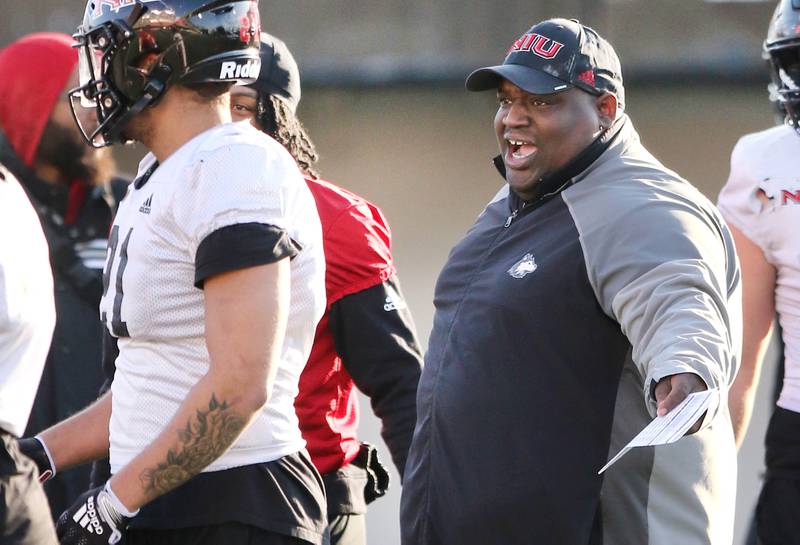 Northern Illinois University football head coach Thomas Hammock gives instruction to a player during spring practice Friday, April 7, 2023, in Huskie Stadium at NIU in DeKalb.