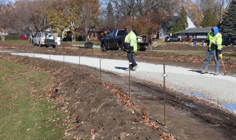 Crews with Gillian Construction repair the walking path around Baker Lake on Monday, Nov. 10, 2025 in Peru. The walking path is nearly half poured. It's been one-month since construction began. Work includes a 10-foot wide concrete path with secondary concrete paths also added, connecting with the new parking lot near Lighted Way and connecting with the parking lot, playground, and shelter on the west side of Baker Lake. The new path will be wider by 2 feet than the current one. The park remains closed to the public. The project will be completed in early December.