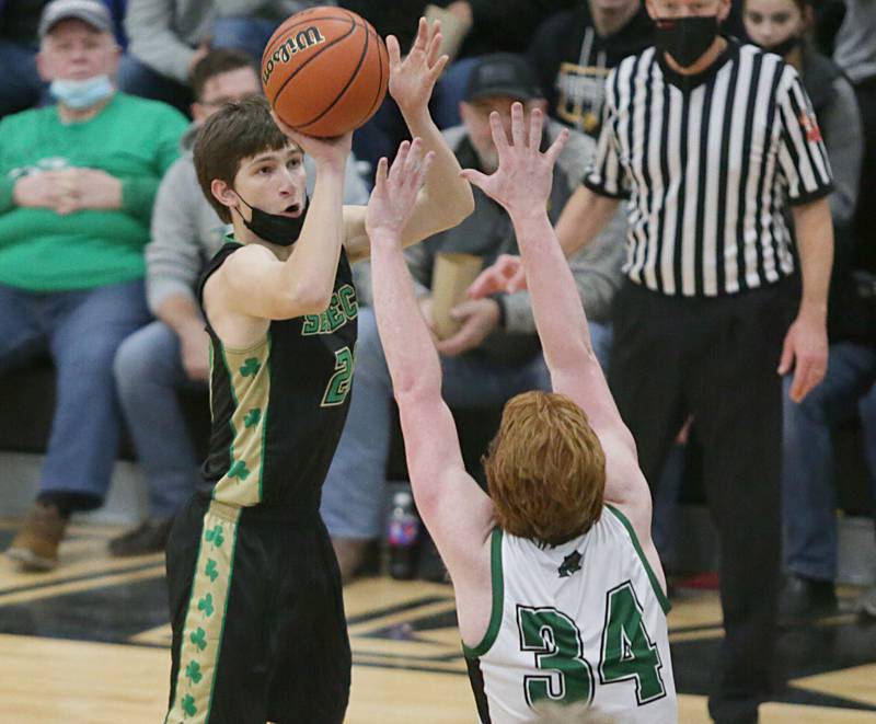 Seneca’s Calvin Maierhofer (20) shoots a three-point shot over Midland’s Ryan Riddell (34) at the Tri-County Conference Tournament on Friday Jan. 28, 2022 in Granville.