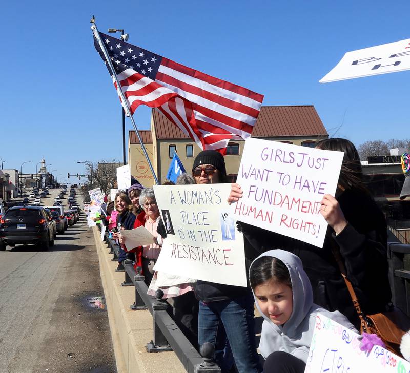 Hundreds of people lined the Route 38 bridge over the Fox River in support of International Women’s Day in Geneva on Saturday, March 8th, 2025.