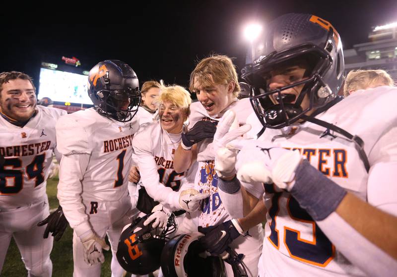 Members of the Rochester football team celebrate on the field as they win the Class 4A State football championship on Friday, Nov, 24, 2023 at Hancock Stadium in Normal.