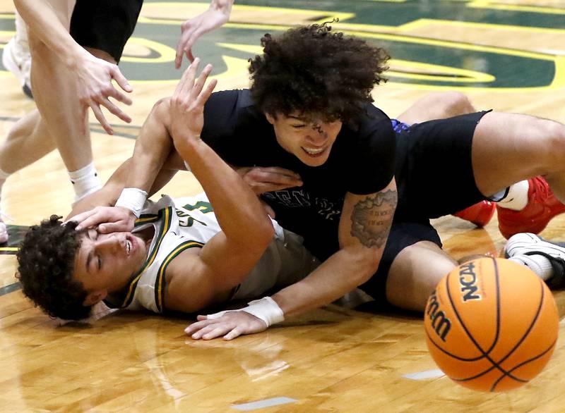 Burlington Central's Caden West (right) tries push off of Crystal Lake South's Anthony Demirov as they try to get a loose ball during a Fox Valley Conference basketball game on Tuesday, Jan. 28, 2025, at Crystal Lake South High School.