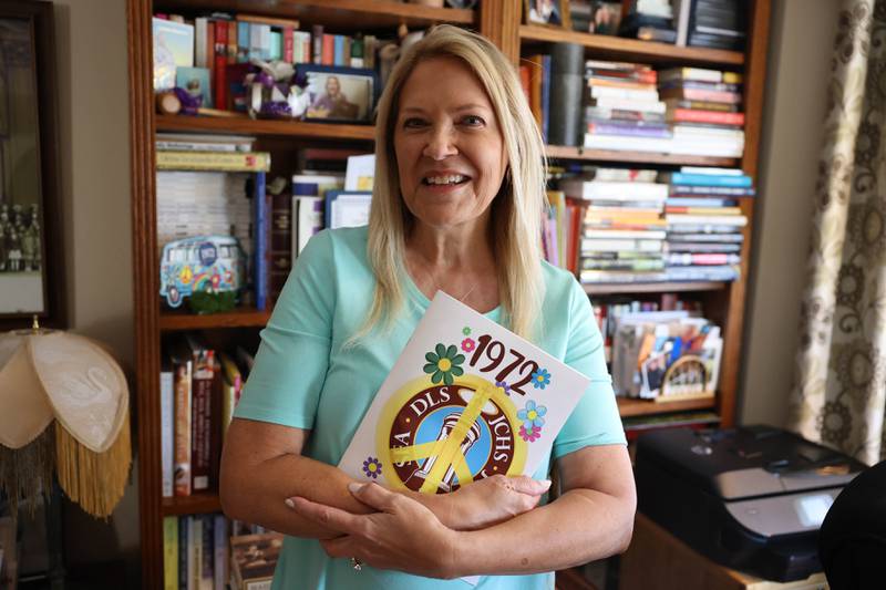 Marianne Wolf-Astrauskas is seen on Tuesday, Sept. 20, 2022, in Orland Park, holding the book distributed at her 50th reunion earlier in September. Wolf-Astrauskas created this 70-page book for the combined 50th reunion of the former Catholic High School and St. Francis Academy.