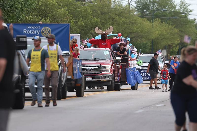 Mascot Moose stands in the back of the Moose Riders truck in the Old Canal Days Parade on Friday June 7, 2024 in Lockport.