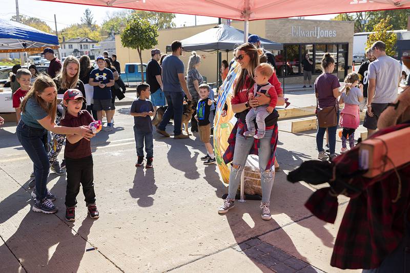 Avery Ortiz, 6, of Dixon takes aim at a booth Saturday, Oct. 22, 2022 during Dixon’s Scarecrow Fest. Lots of fun things to do and see during the annual festival.