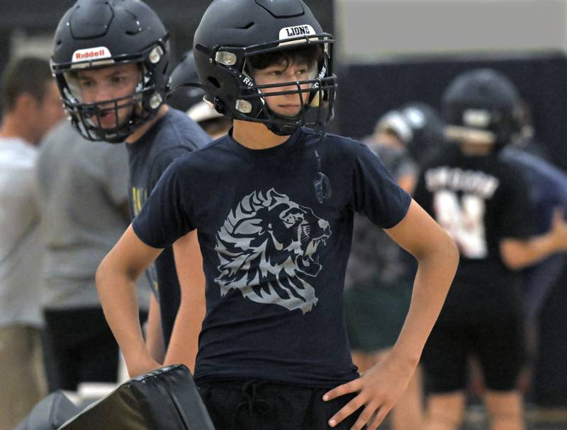 Freshman Connor Roehm wears a shirt with the school mascot at Lisle High School football practice in the school gymnasium on Tuesday, August 12, 2025.