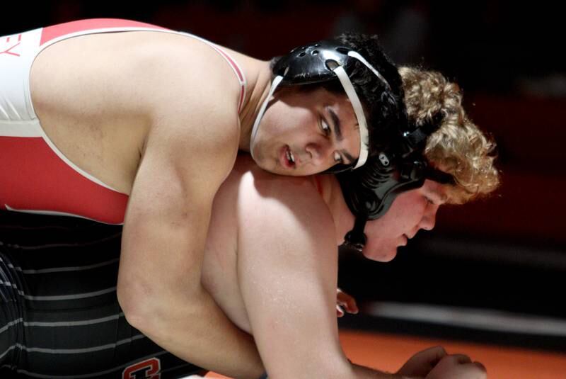 Crystal Lake Central’s Logan Gough battles Huntley’s Markos Mihalopolus, top, in a 285-pound bout in varsity wrestling at Crystal Lake Friday.  Mihalopolus won the match.