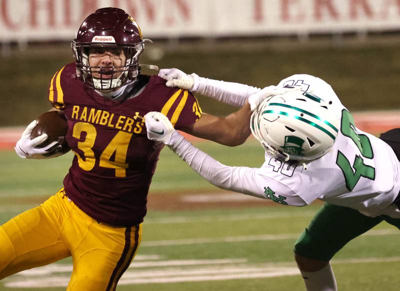 Loyola Academy's Drew MacPherson tries to pull free from York’s Noah Zmrhal during their Class 8A state championship game Saturday, Nov. 30, 2024, in Hancock Stadium at Illinois State University in Normal.