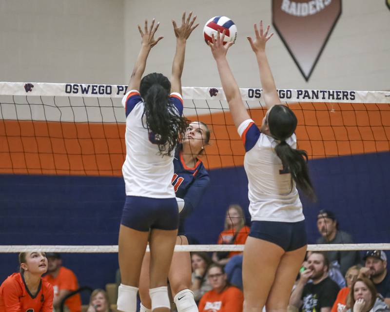 Oswego's Renee Eggers (11) spikes the ball during volleyball match between Romeoville at Oswego. Oct 16, 2025.