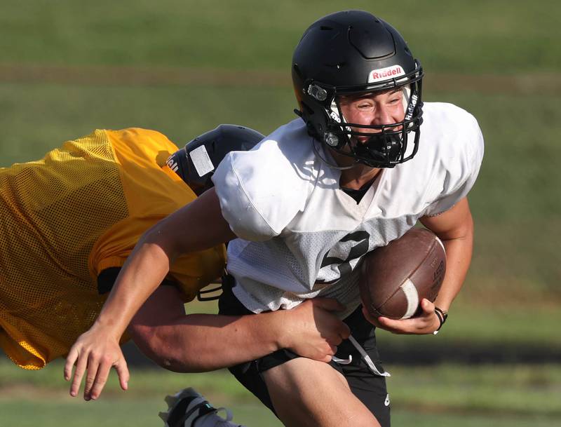 Sycamore’s Griffin Larson tries to shake off a Lena-Winslow defender Thursday, July 24, 2025, during a joint practice with Byron, Lena-Winslow and Sycamore at Sycamore High School.
