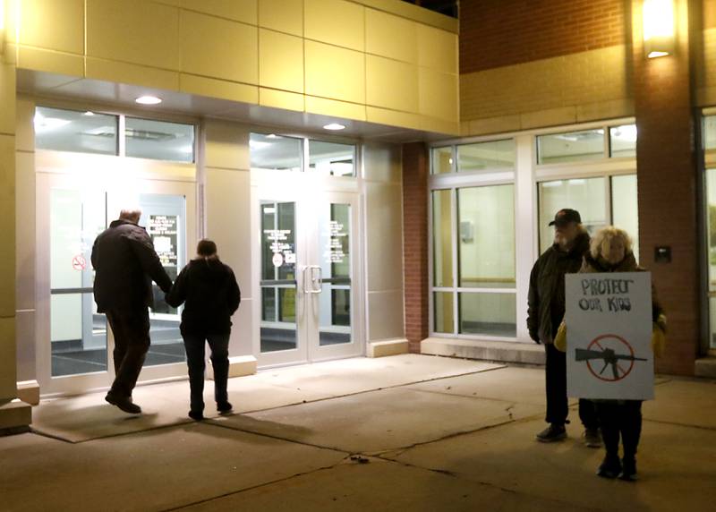 A protester stands outside the McHenry County Administrative Building ahead of a McHenry County Board meeting about the proposed resolution opposing the Illinois gun ban and supporting its repeal in the Illinois State Legislature.