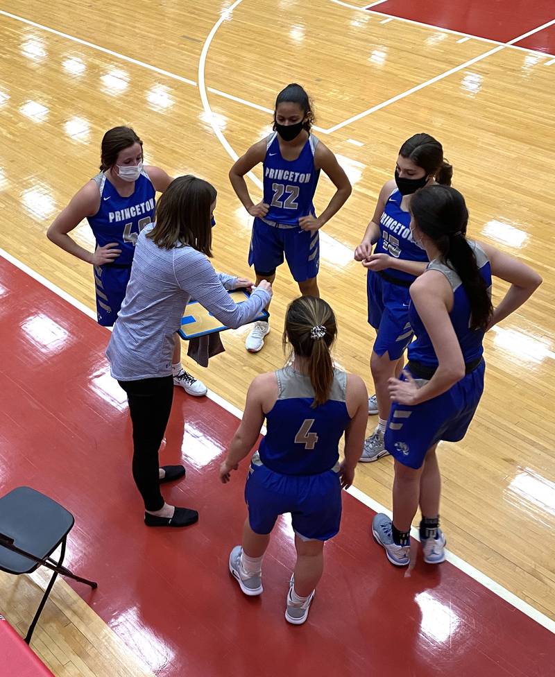 Princeton girls basketball coach Tiffany Gonigam (at left) draws up a game plan for her Lady Tigers during a timeout Friday, Feb. 19, 2021, at Kingman Gym in Ottawa.