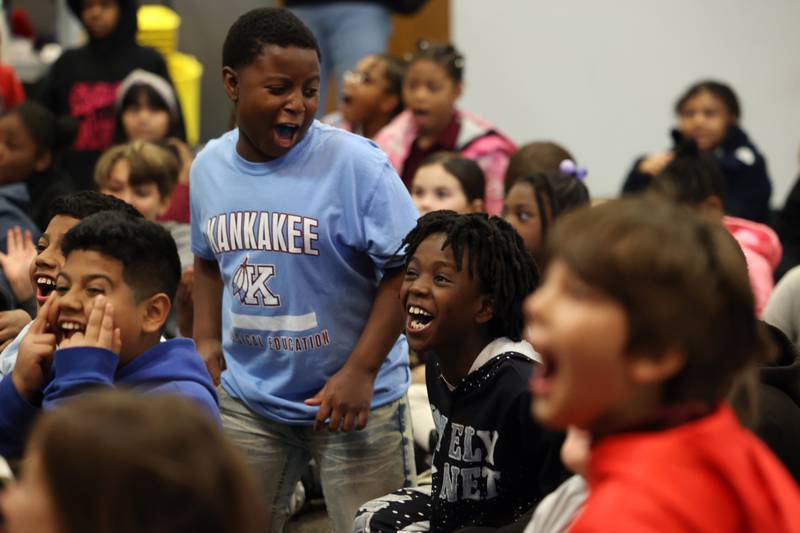 Kankakee fourth graders Daimir Marshall, center, and Jermaine Cook, left, react to a magic trick during the Impossible Science event at the Kankakee First Church of the Nazarene on May 5, 2026.