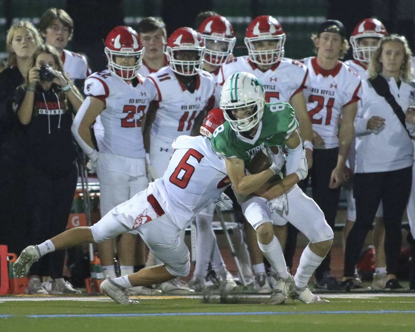 York's Charlie Specht (8) is tackled near the sidelines by Hinsdale Central's Vincent Arnold (6) during football game between Hinsdale Central at York. Oct 8, 2021.