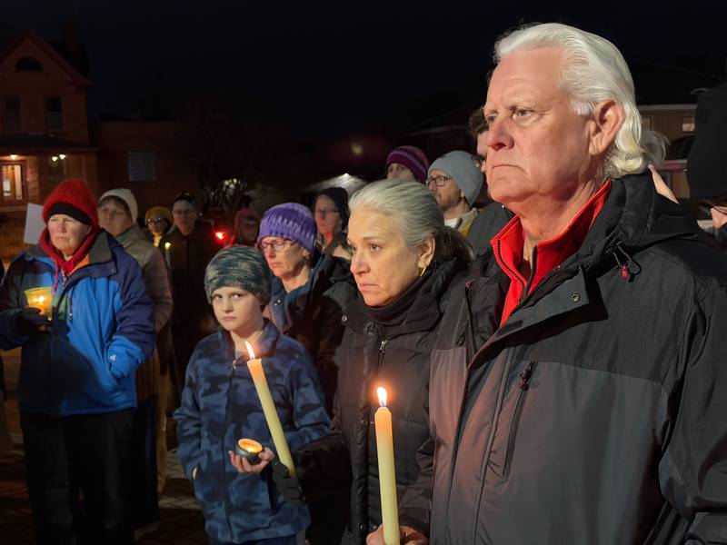 DeKalb area residents hold lit candles and stand for a moment of silence during a peace vigil downtown on Friday, Jan. 9, 2026. Organizers called the vigil to remember the life of Renee Nicole Good, 37, a Minnesota mother who was shot and killed by a federal immigration agent in Minneapolis on Jan. 7, 2026.