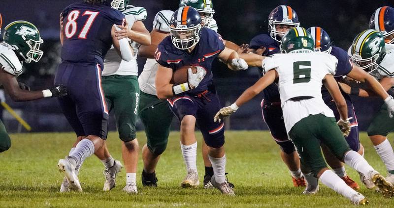 Oswego’s Dylan King (20) carries the ball against Plainfield Central during a football game at Oswego High School on Friday, Sept. 8, 2023.