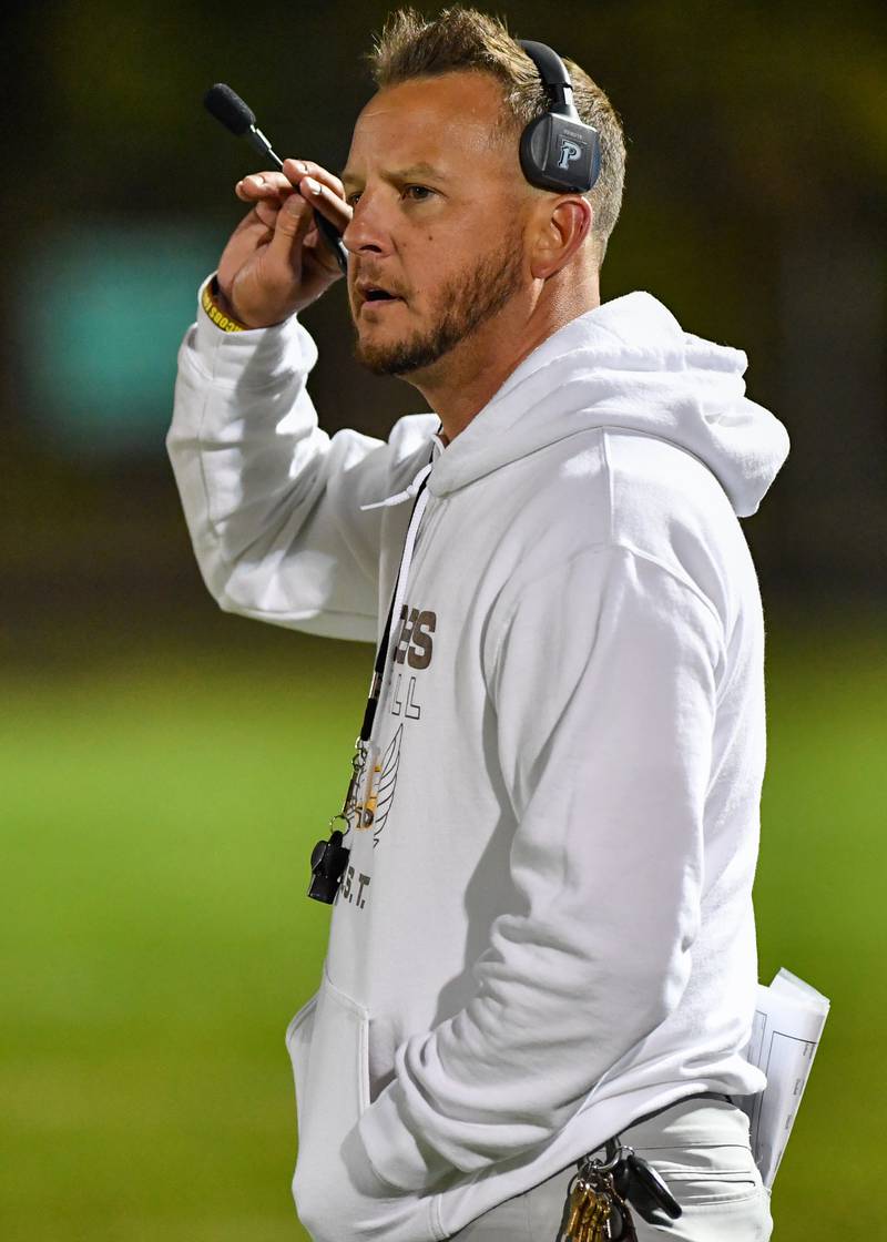 Jacob's head coach Brian Zimmerman talks with his players during a break in play against their Fox Valley Conference rival Cary Grove on Friday, Oct. 6, 2022 in Algonquin.