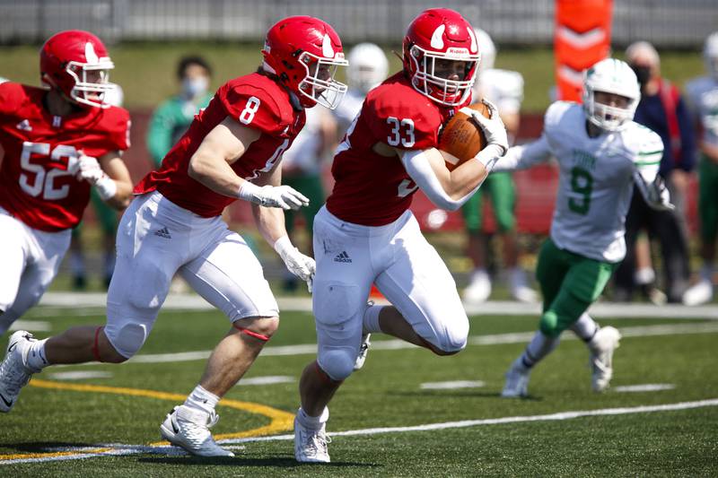 Hinsdale Central’s Sean Allison (right) intercepts a pass during their football game against York at Hinsdale Central High School in Hinsdale, Ill., on Saturday, April 3, 2021.