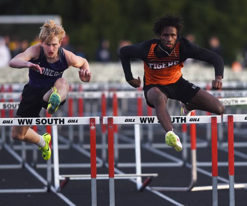 Wheaton Warrenville South’s Amari Williams, right ,clears the final hurdle in tthe 110-meter hurdles during the Red Grange boys track meet at Wheaton Warrenville South High School on Friday, April 19, 2024 in Wheaton.