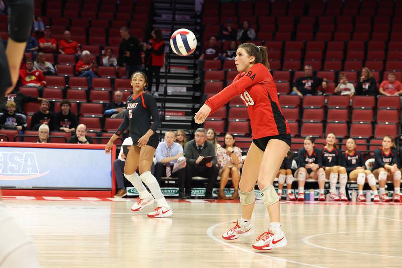 Benet Academy's Claire Weathers volleys a serve during Benet Academy's victory in two sets, 25-23, 25-16, over Lockport in the IHSA Class 4A State semifinals on Friday, Nov. 14, 2025.