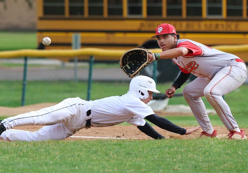 Kaneland's Caleb Cornell dives back to first as LaSalle-Peru's Monti Lorenzi waits for the throw Tuesday, May 12, 2026, during their game at Kaneland High School in Maple Park.