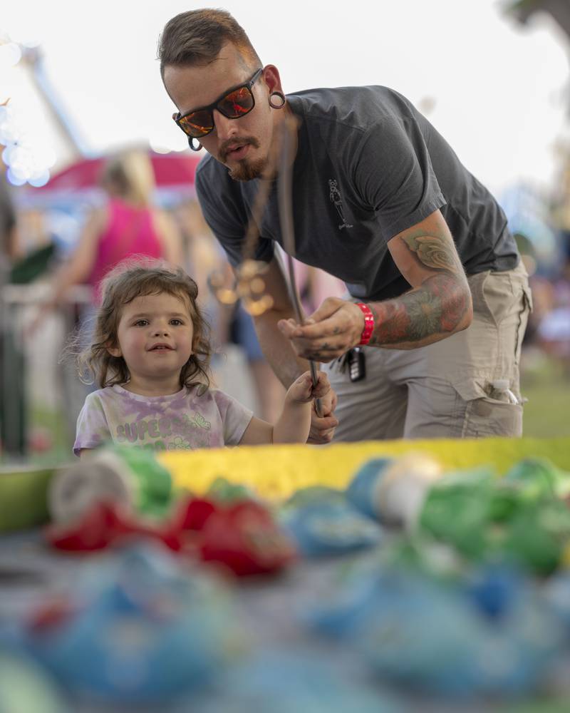 Hunter Perhach and his daughter Willow play the fishing game at Streatorfest on August 2, 2024.