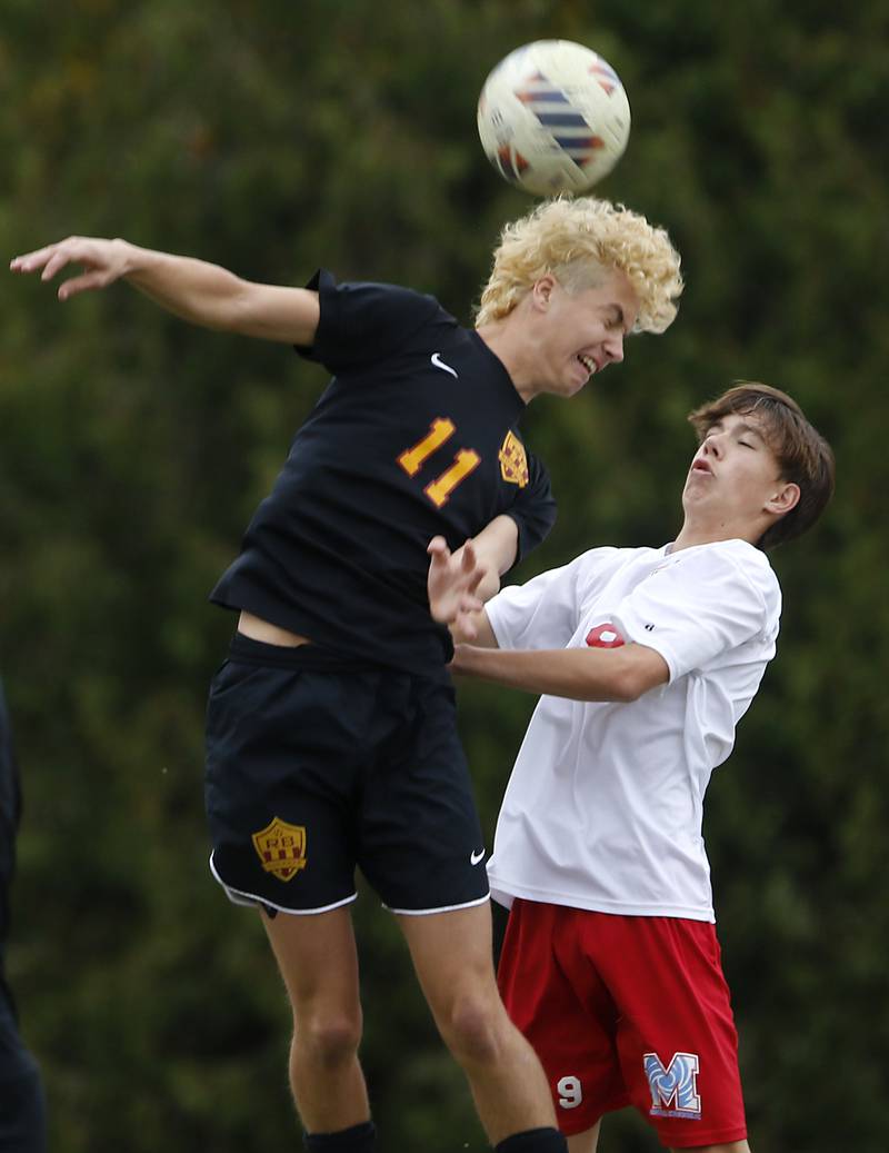 Richmond-Burton's Jack Meyer heads the ball away fromMarian Central's Jan Bajda during the IHSA Class 1A Marian Central Regional Boys Soccer Final match on Tuesday, Oct. 22, 2024, at Marian Central High School in Woodstock.