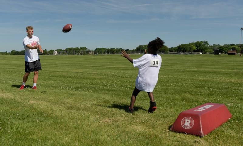 NIU’s Cole Tucker tosses the ball to a campers during the inaugural Legends of the 60115 Football Camp with in DeKalb on Sunday, June 26, 2022.