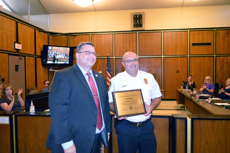 Illinois Association of Chiefs of Police Executive Director Kenny Winslow, left, and Rock Falls Police Chief Dave Pilgrim pose for a photo during the Oct. 3, 2023, Rock Falls City Council meeting. Winslow presented Pilgrim with a plaque recognizing Pilgrim's success at earning police chief certification through the ILACP's voluntary program.