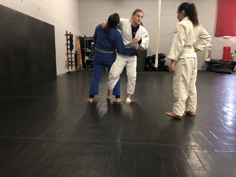 Sara Golden, center, uses sparring partner Kaylee Baginski, left, to show how to use the arm and leg to throw a person in judo to Amanda Keilman. Golden hopes to compete in the 2024 Paris Olympic Games.