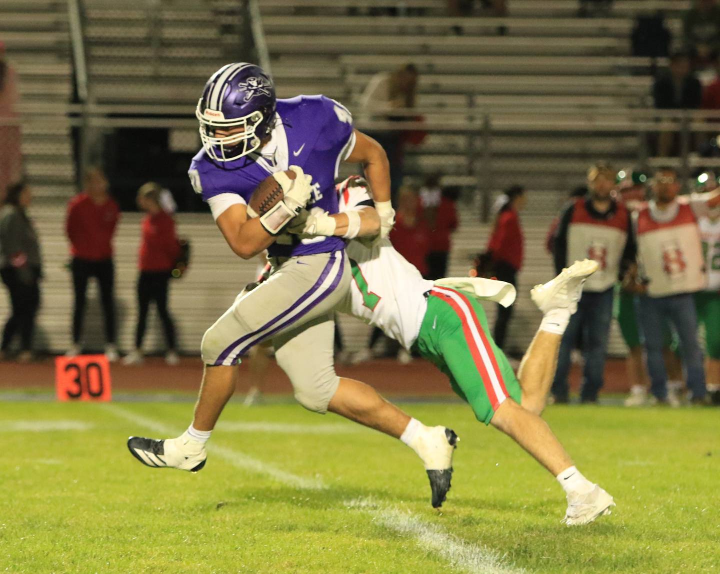 Rochelle fullback Roman Villalobos (40) tries to break free of a La Salle-Peru defender during Friday's game in Rochelle.