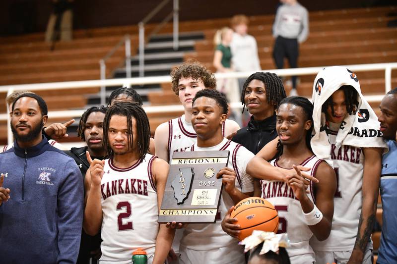 Kankakee players pose with the IHSA Class 3A Morris Regional championship plaque following the Kays' 85-50 victory over Sterling on Friday, Feb. 28.