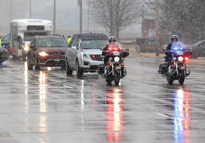The hearse carrying the casket of former DeKalb County Sheriff Roger Scott travels down Bethany Road Friday, March 7, 2025, on its way to Fairview Park Cemetery in DeKalb following his memorial service at Bethany Road Bible Church. Scott, who was the county sheriff for 36 years, died on February 23 at the age of 78.