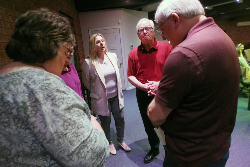 Pastor Kim Lunstrom, of Round Lake, Nancy Pedley, of Ingleside, Carmella Antczak,  Pastor Kent Lunstrom, both of Round Lake, and Gary Riendeau, of Island Lake, unite in prayer Thursday, May 4, 2023, during the Grant Township National Day of Prayer Gathering at CrossPoint Church in Ingleside.