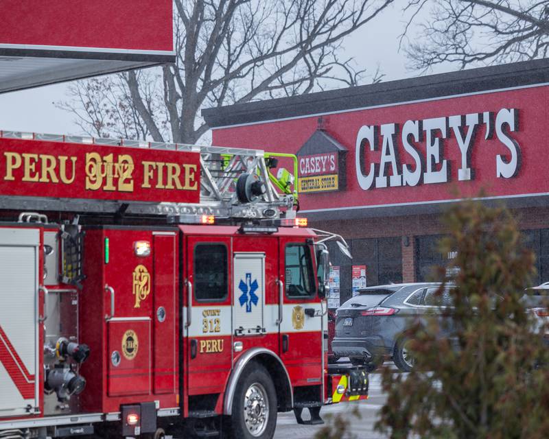 Peru Fire and Police respond to internal electrical fire of vehicle near gas pump on Tuesday, December 30, 2025 at Casey's on 1100 Shooting Park Road in Peru. The fire was extinguished by 15 year old driver Jesus Gonzalez of Streator.