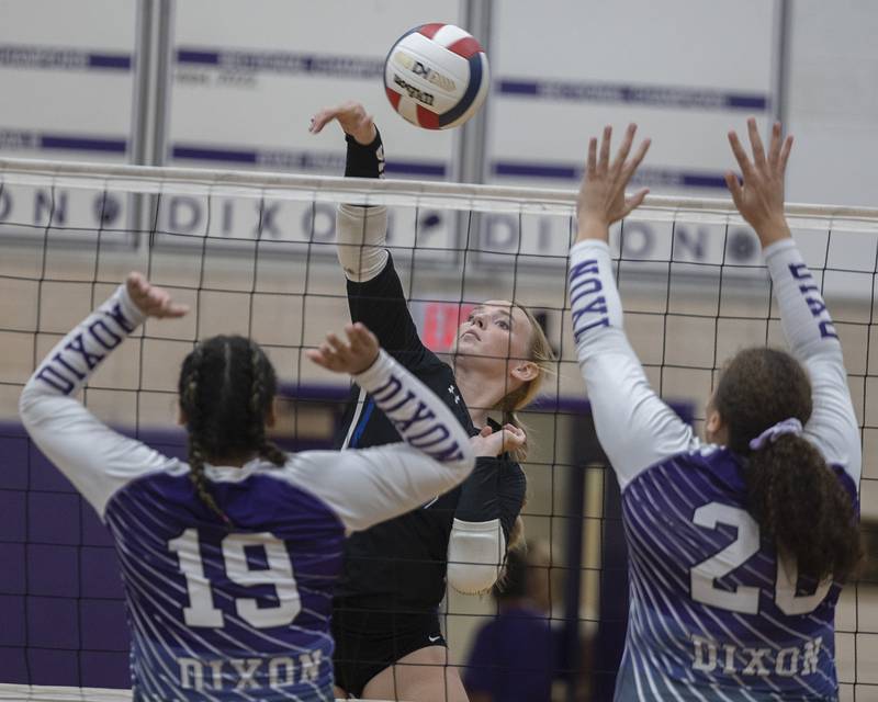 Newman’s Jess Johns plays a shot against Dixon’s Hallie Williamson (left) and Olivia Cox Monday, August 28, 2023 during a non-conference match-up in Dixon.