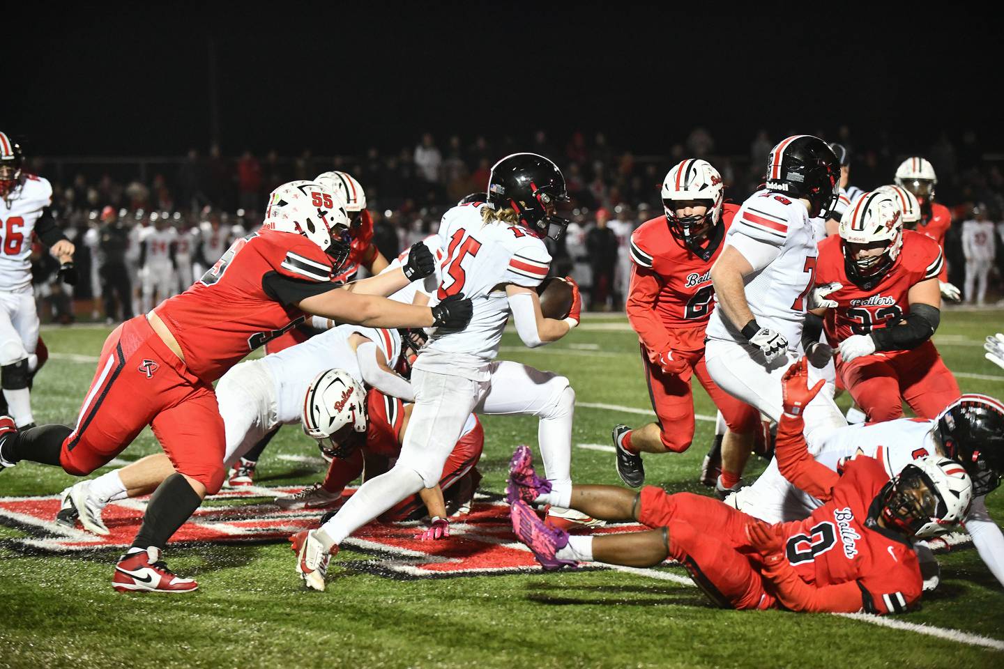 Lincoln-Way Central's Tyler Tulk evades Bradley-Bourbonnais defenders Friday during the Knight's 28-16 victory over Bradley-Bourbonnais in a IHSA Class 7A quarterfinal in Bradley.