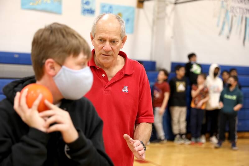 Physical education teacher Corey Toppel teaches a lesson on the shot put to sixth graders at Glen Crest MIddle School in Glen Ellyn. Toppel has been a teacher at the school for 32 years.